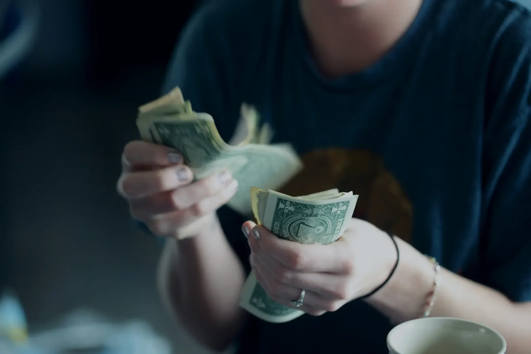 Women holding and counting cash