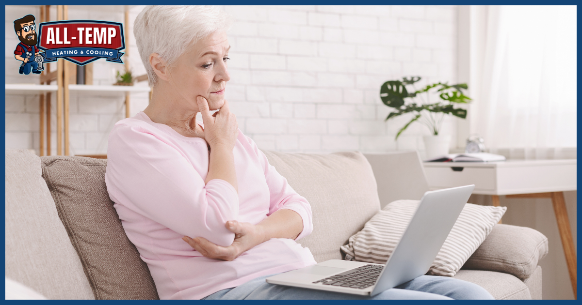 Woman sitting on sofa with laptop