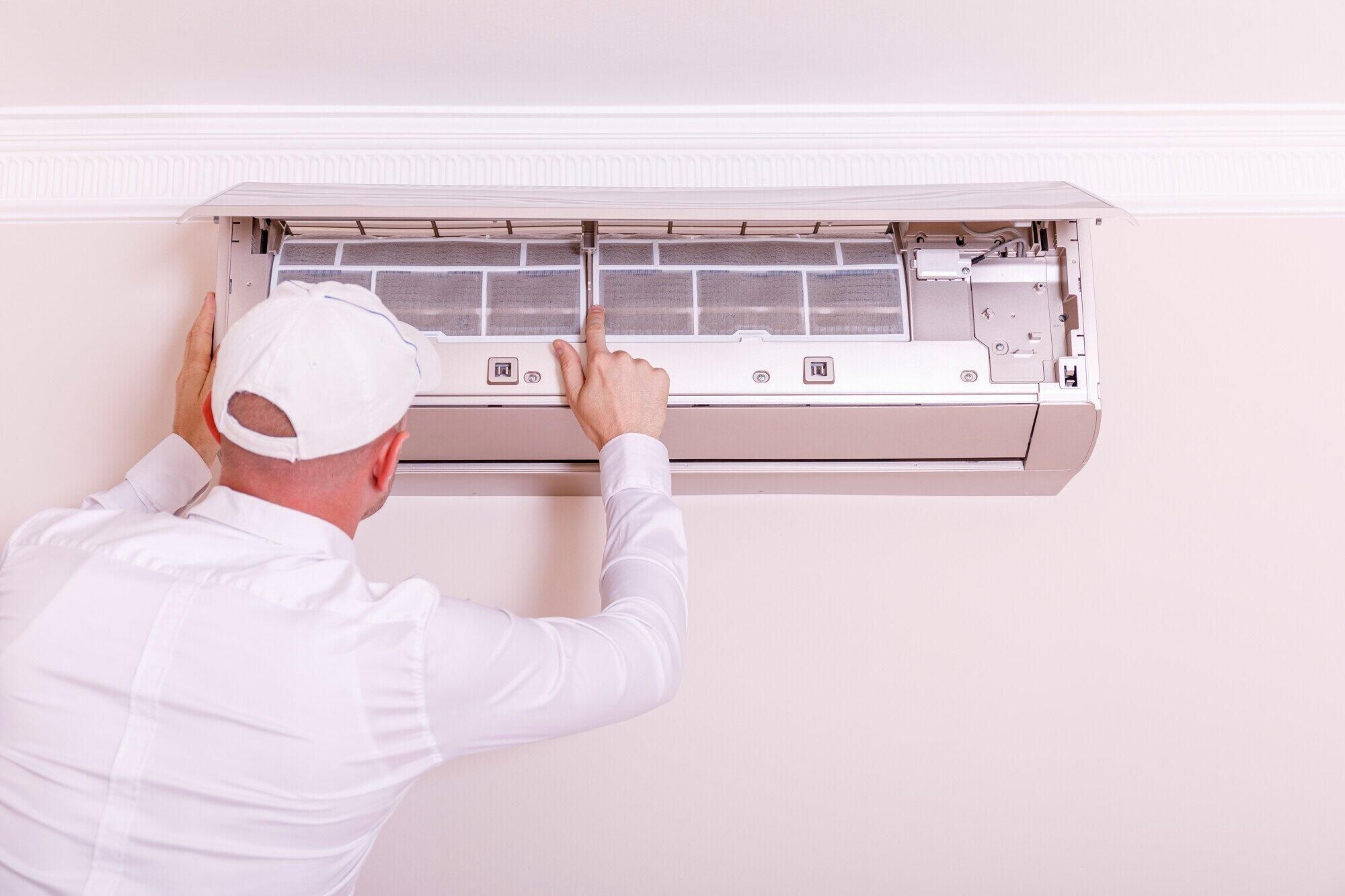 Cleaning air conditioner filter on wall unit