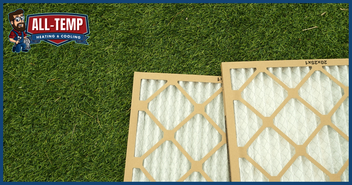 Two air filters laying on the grass.