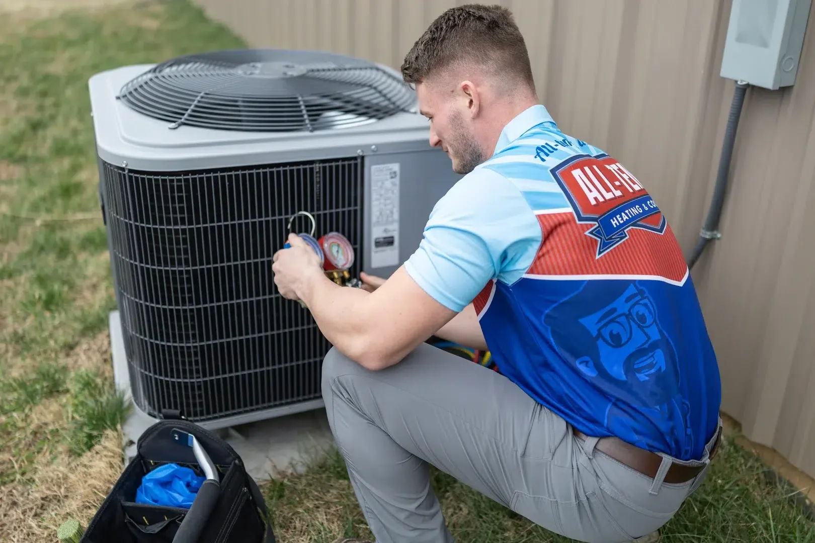 AC refrigerant leak technician inspecting outdoor unit