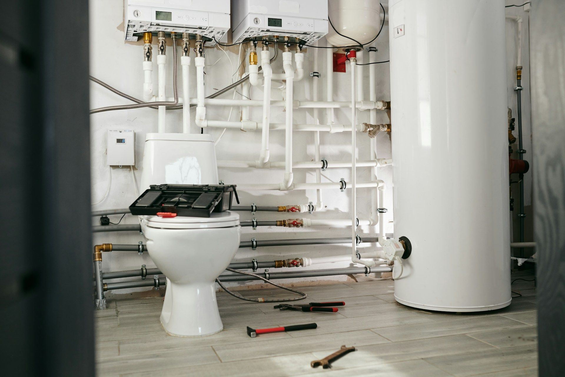 Residential boiler and water heater installation with plumbing system
