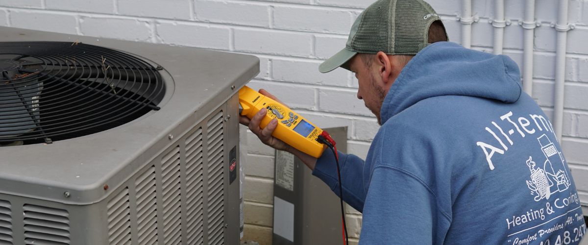 Image of an AC specialist working on a unit